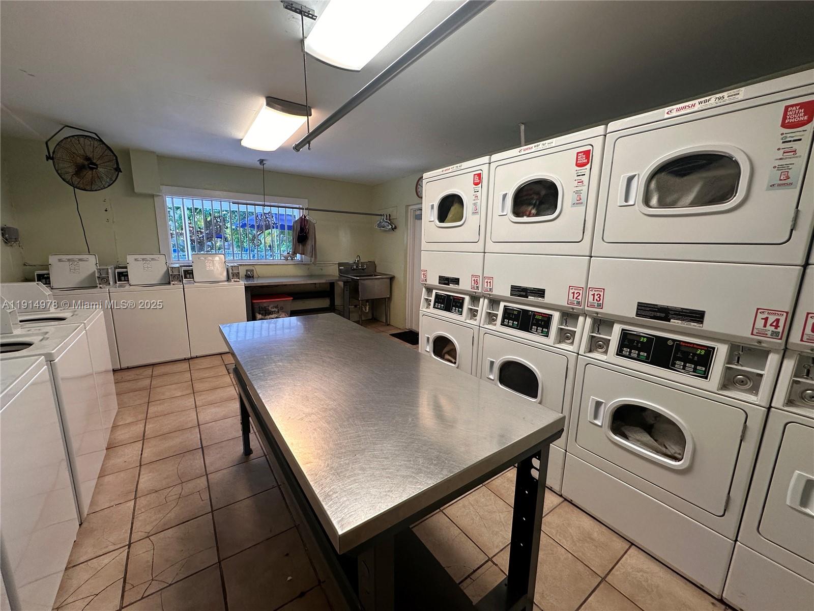 7940 Southwest 55th Avenue, Unit 67D Miami, FL 33143 - Photo 10 of 16 a view of kitchen with a stove a microwave and a table
