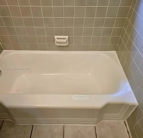 a view of an empty room and wooden floor