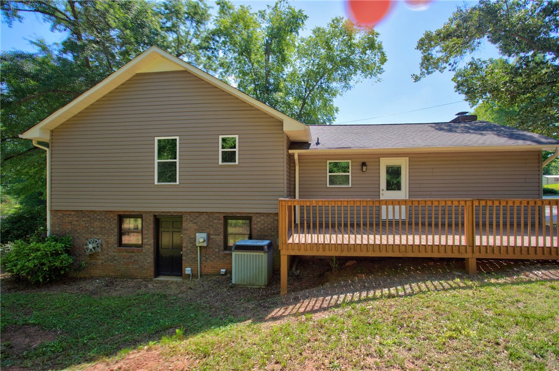 712 Beech Drive Seneca, SC 29678 - Photo 5 of 41 A spacious wooden deck extends from this residence, offering an inviting outdoor living space.