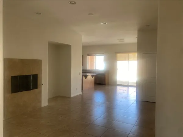 a view of a livingroom with wooden floor and a fireplace