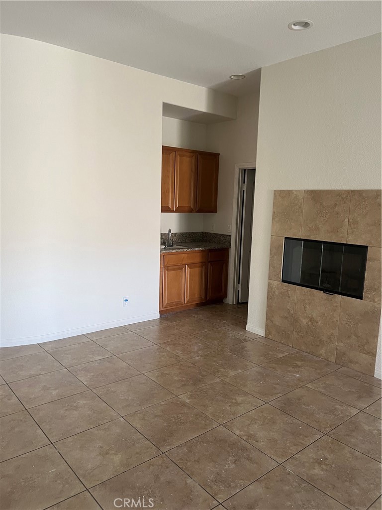 45954 Meritage Lane Coachella, CA 92236 - Photo 4 of 11 a view of kitchen and empty room with fireplace
