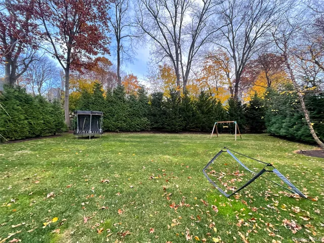 a view of a backyard with a trampoline
