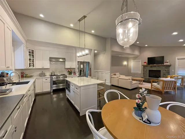 a kitchen with sink a stove and chairs