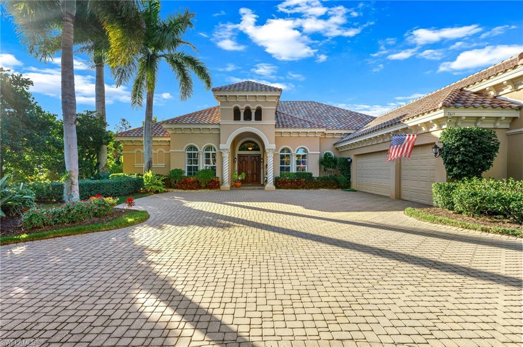 View of front of home featuring stucco siding, decorative driveway, and a garage