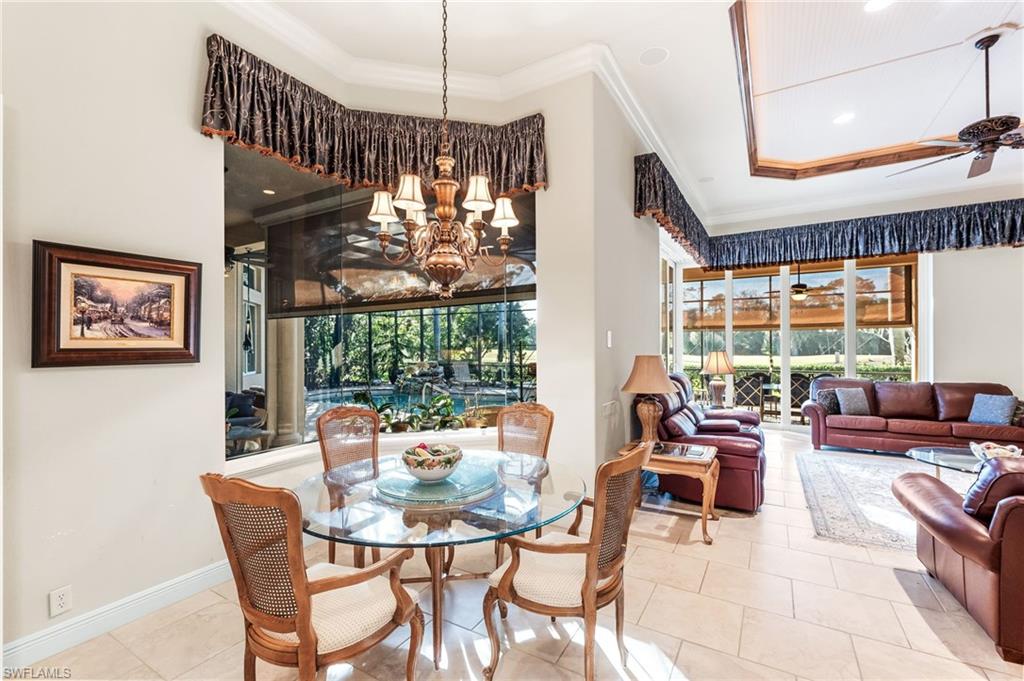 7615 Palmer Court Naples, FL 34113 - Photo 15 of 50 Dining room featuring ceiling fan, healthy amount of natural light, ornamental molding, hanging lights, and tile patterned floors