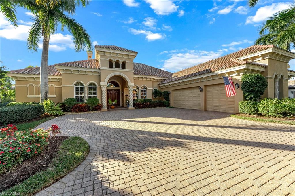 7615 Palmer Court Naples, FL 34113 - Photo 2 of 50 Mediterranean / spanish-style home with stucco siding, decorative driveway, a tiled roof, and an attached garage