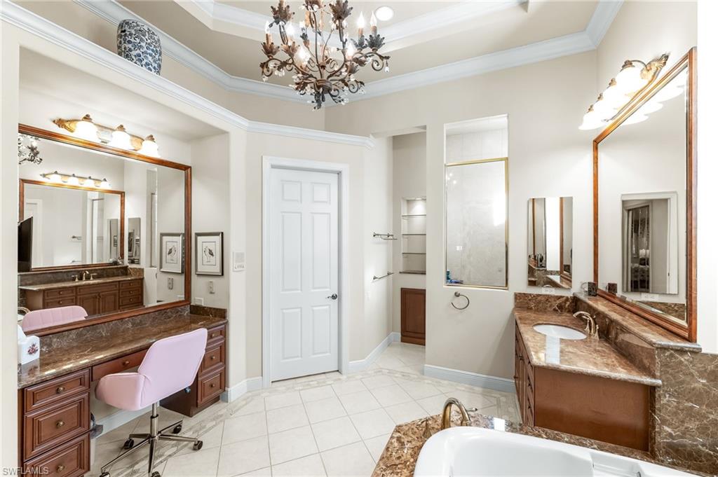 7615 Palmer Court Naples, FL 34113 - Photo 25 of 50 Full bath featuring ornamental molding, two vanities, hanging lights, light tile patterned floors, and a bathtub