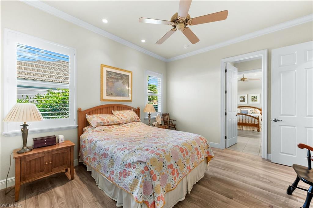 7615 Palmer Court Naples, FL 34113 - Photo 28 of 50 Bedroom with light wood-style flooring, crown molding, ceiling fan, and recessed lighting
