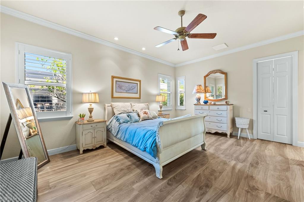 7615 Palmer Court Naples, FL 34113 - Photo 32 of 50 Bedroom featuring light wood-type flooring, ornamental molding, a ceiling fan, and recessed lighting