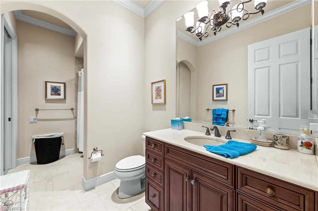 7615 Palmer Court Naples, FL 34113 - Photo 33 of 50 Bathroom featuring curtained shower, vanity, and ornamental molding