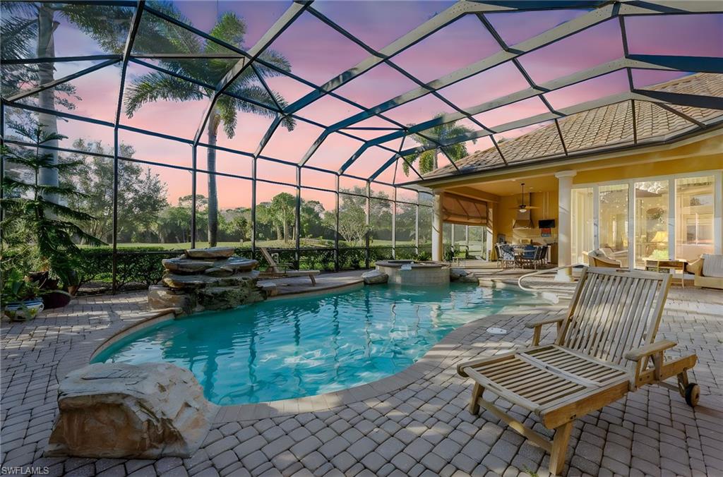 7615 Palmer Court Naples, FL 34113 - Photo 39 of 50 Integrated pool / spa with a sunroom, glass enclosure, and a patio area