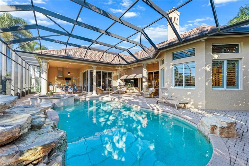 7615 Palmer Court Naples, FL 34113 - Photo 40 of 50 Integrated pool / spa featuring a sunroom, a patio area, and glass enclosure