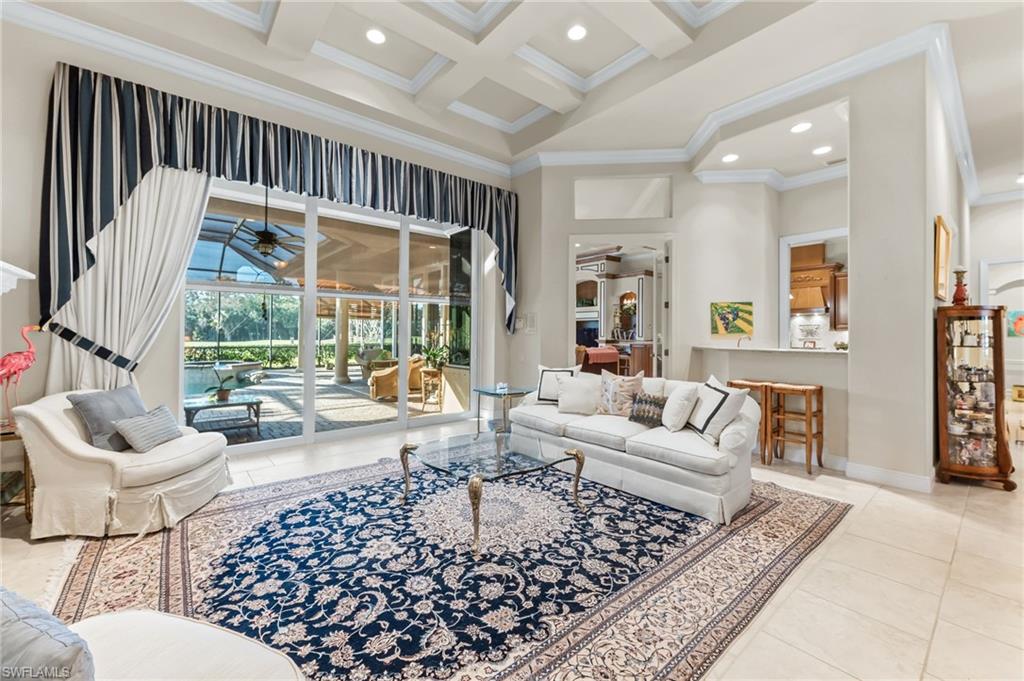 7615 Palmer Court Naples, FL 34113 - Photo 6 of 50 Living area with ceiling fan, a sunroom, coffered ceiling, crown molding, and recessed lighting