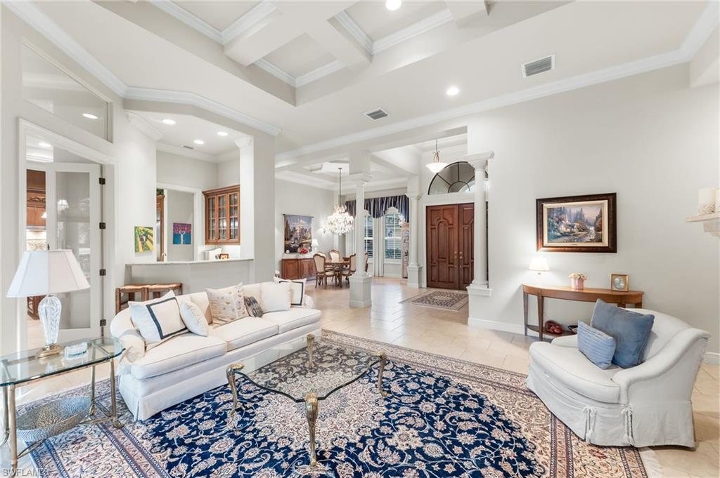 7615 Palmer Court Naples, FL 34113 - Photo 7 of 50 Tiled living room with coffered ceiling, ornamental molding, ornate columns, and recessed lighting