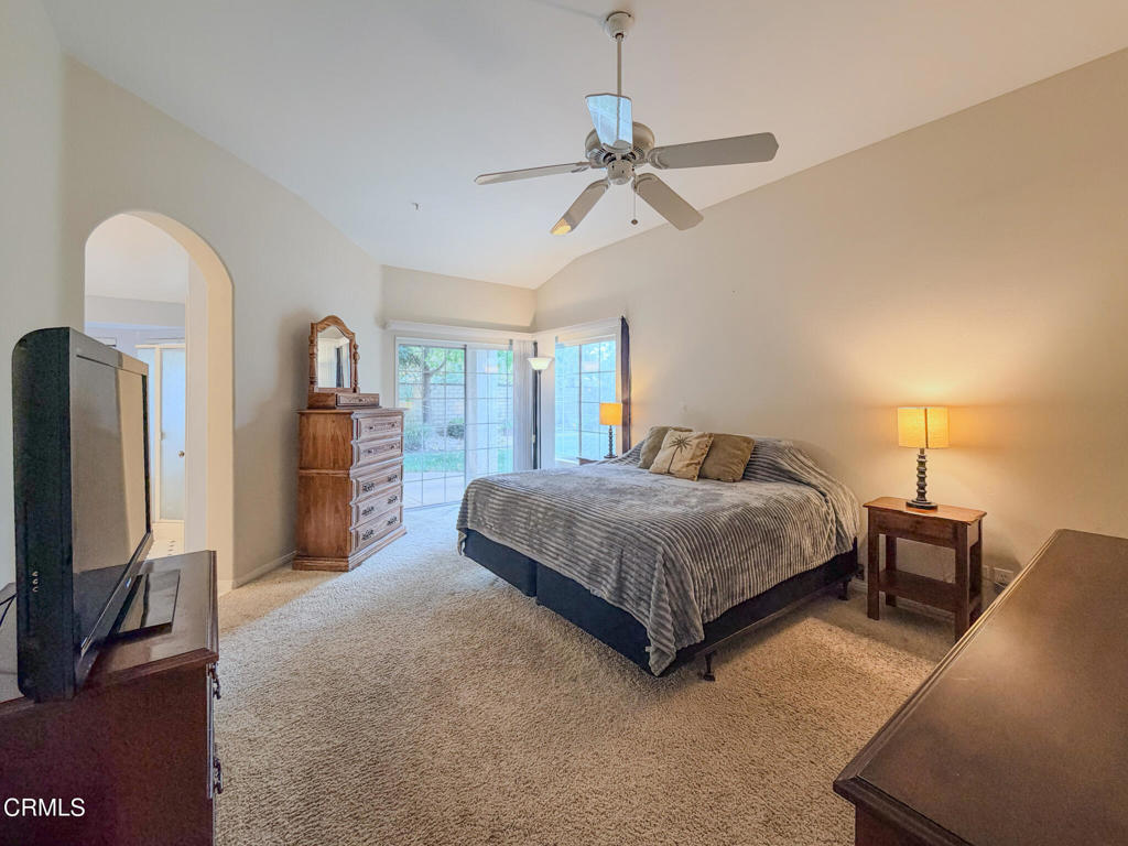 2300 Bayhill Court Oxnard, CA 93036 - Photo 12 of 28 a spacious bedroom with a bed a chandelier and a flat screen television