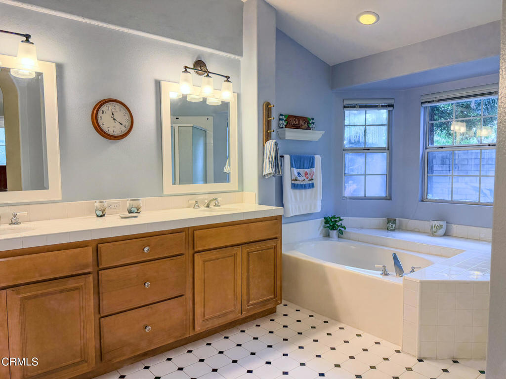 2300 Bayhill Court Oxnard, CA 93036 - Photo 14 of 28 a bathroom with a bathtub sink and mirror