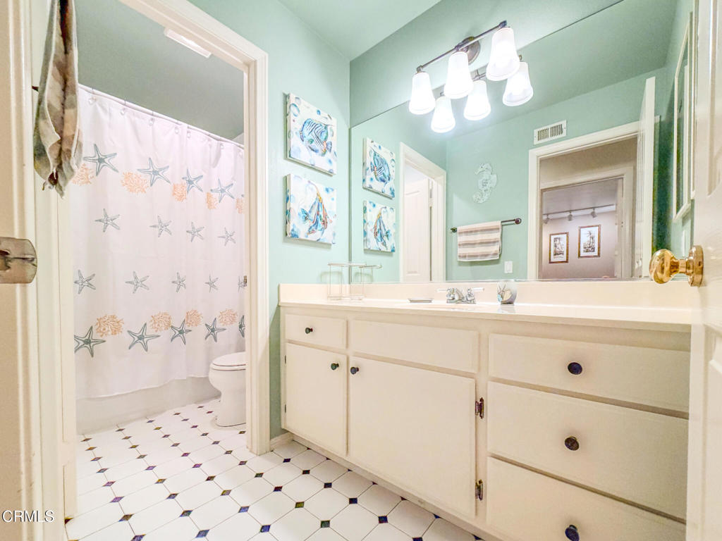 2300 Bayhill Court Oxnard, CA 93036 - Photo 19 of 28 a bathroom with a sink a double vanity and a shower