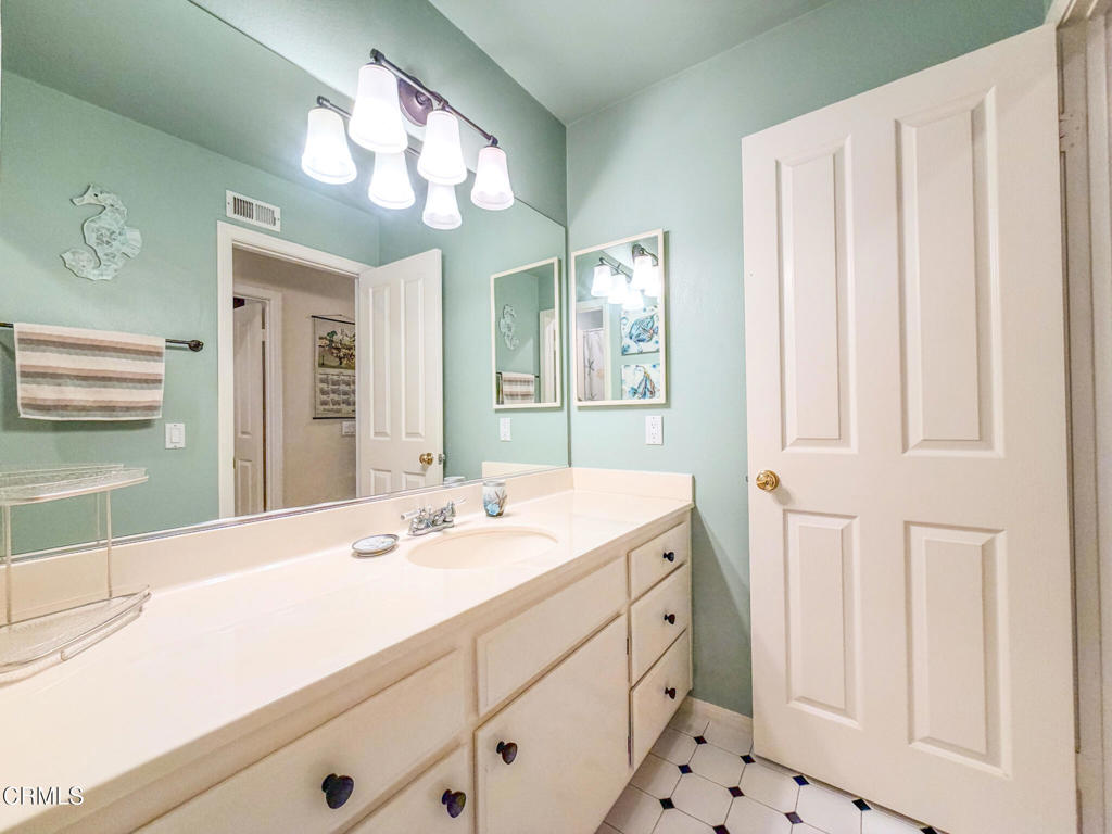 2300 Bayhill Court Oxnard, CA 93036 - Photo 20 of 28 a bathroom with a sink vanity and a mirror