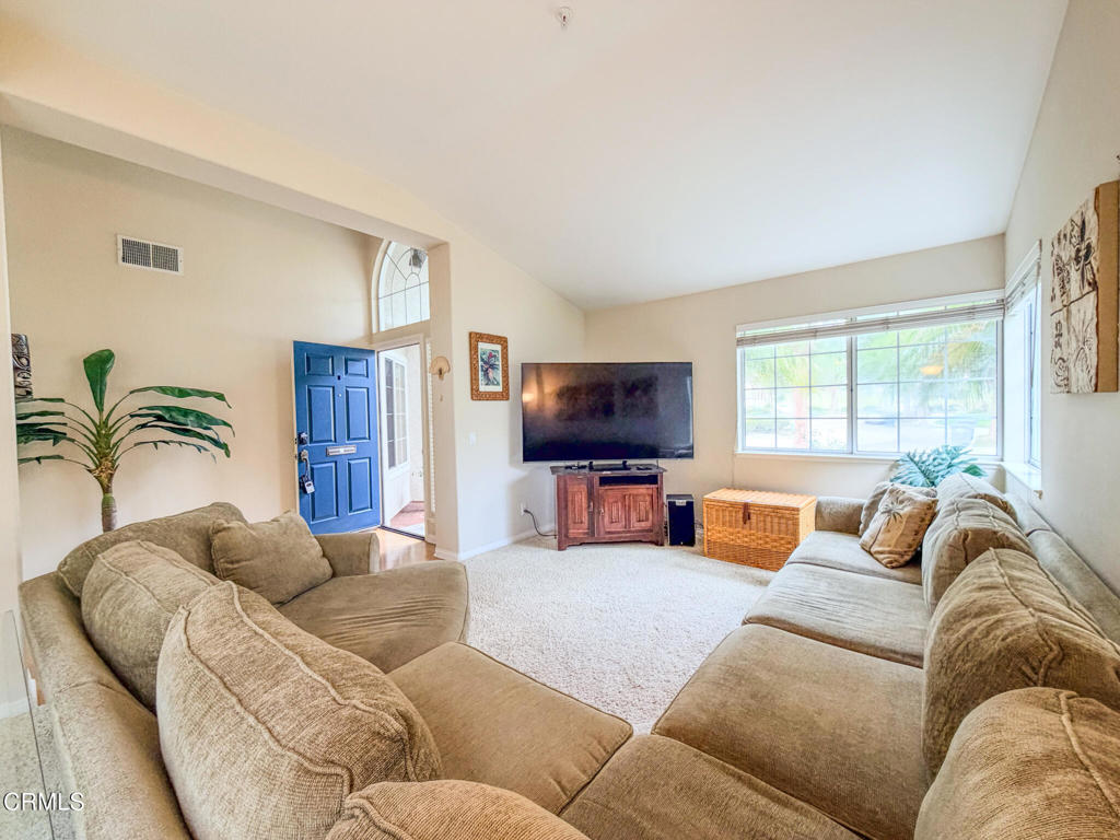 2300 Bayhill Court Oxnard, CA 93036 - Photo 4 of 28 a living room with furniture a large window and a flat screen tv
