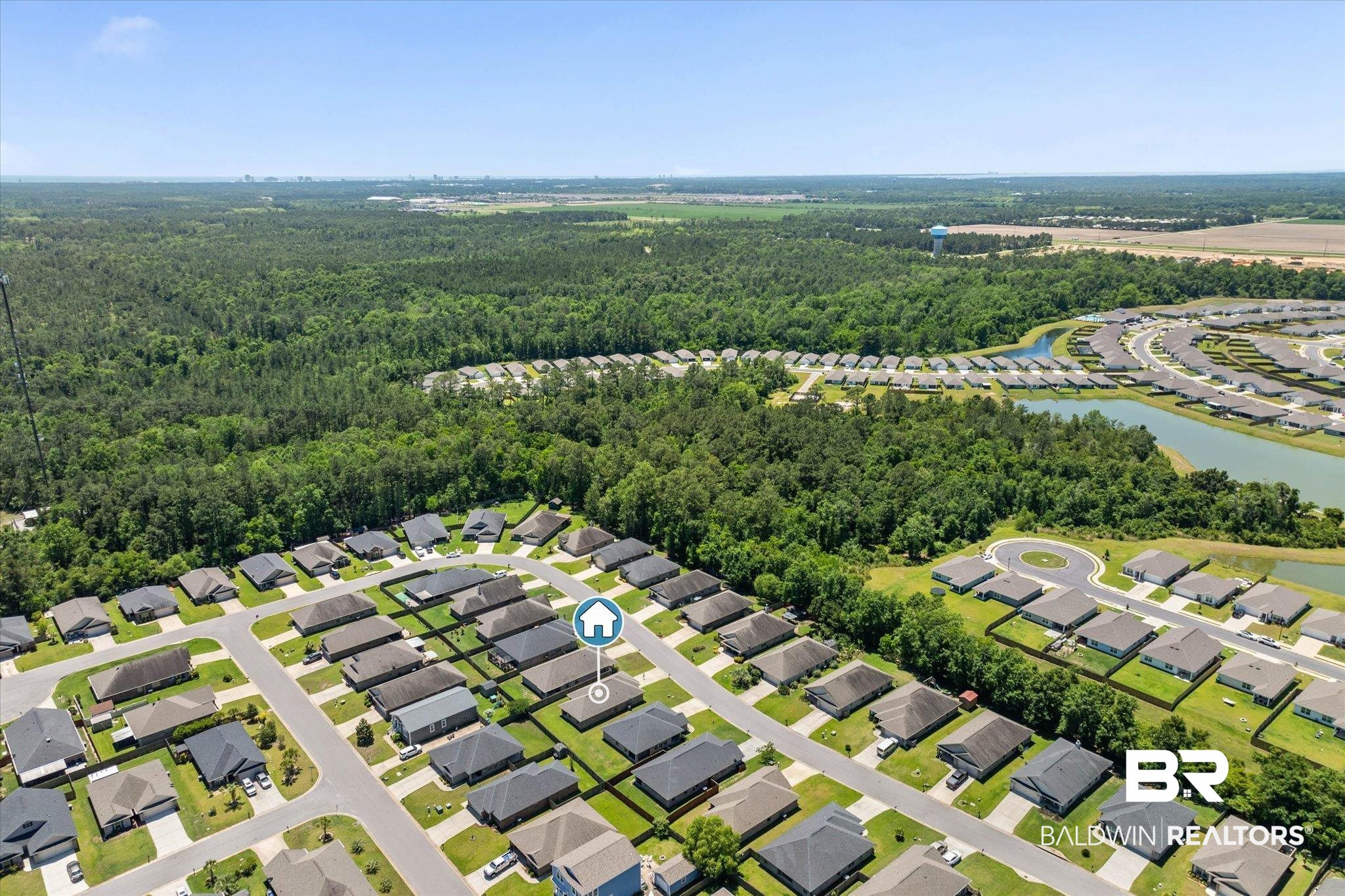 22420 Respite Lane Foley, AL 36535 - Photo 31 of 35 Aerial neighborhood perspective featuring a residential community with uniform single-story homes, interspersed with tree-lined streets and manicured lawns