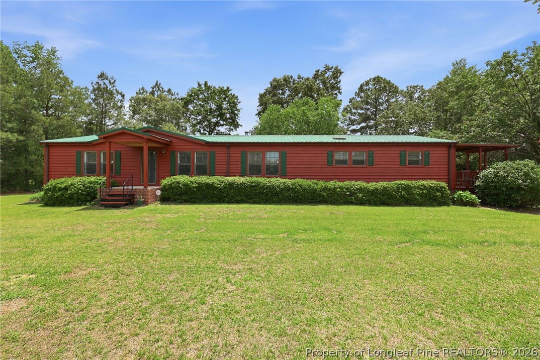 10400 Ruth Vinson Road Autryville, NC 28318 - Photo 13 of 49 a view of a yard in front of a house
