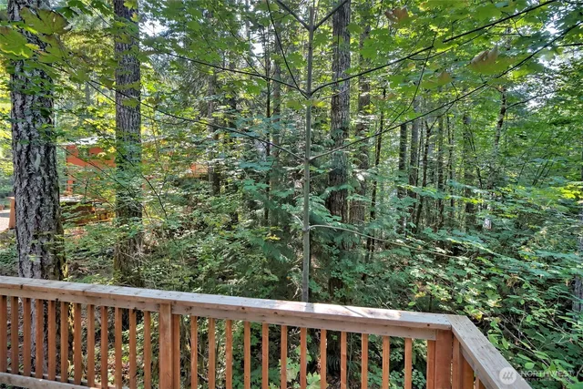 a view of a wooden fence and trees