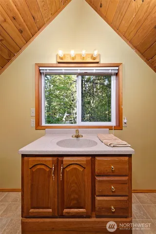 a room with a sink and large window