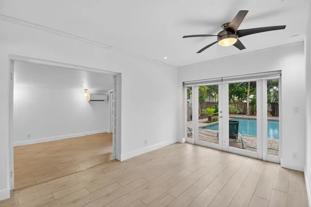 wooden floor in an empty room with a window
