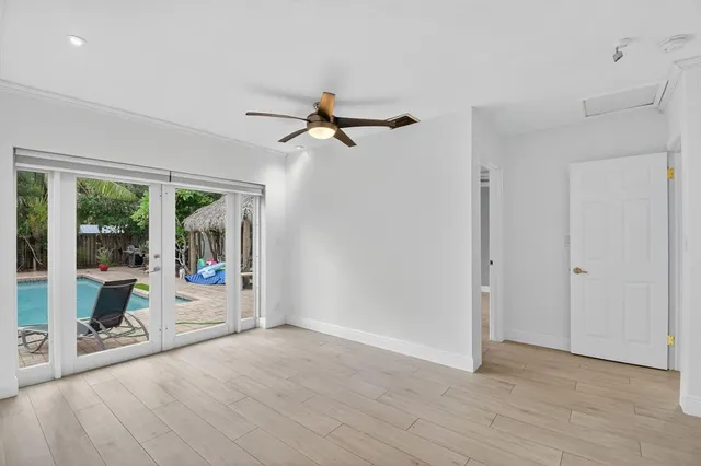 a view of a livingroom with a hardwood floor and ceiling fan