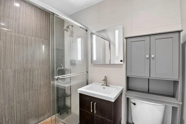 a kitchen with a sink a refrigerator and cabinets