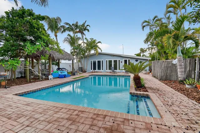 a view of house with swimming pool outdoor seating