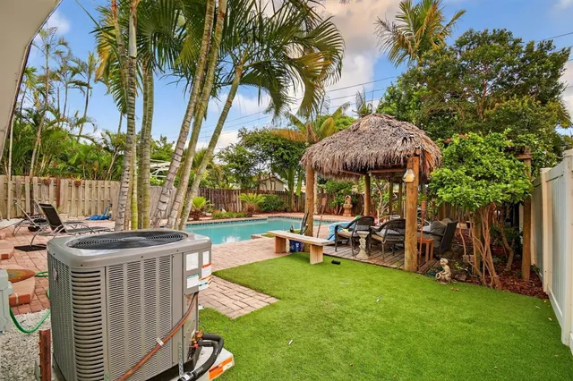 a view of a table and chairs in the patio and a fountain