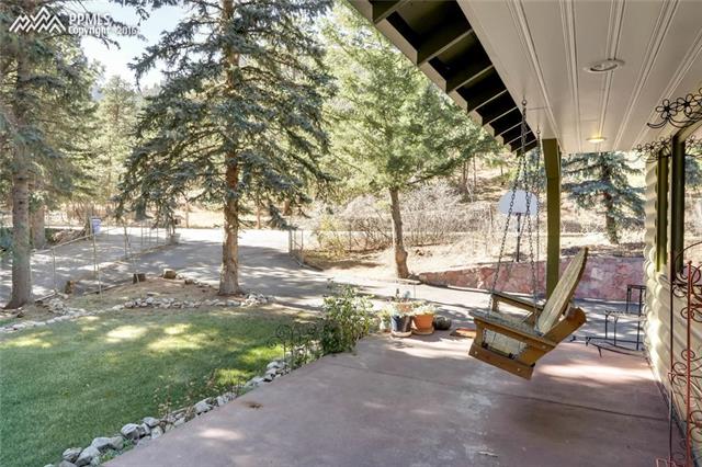 8160 Chipita Park Road Cascade, CO 80809 - Photo 3 of 14 View of the front of the property from the covered patio.
