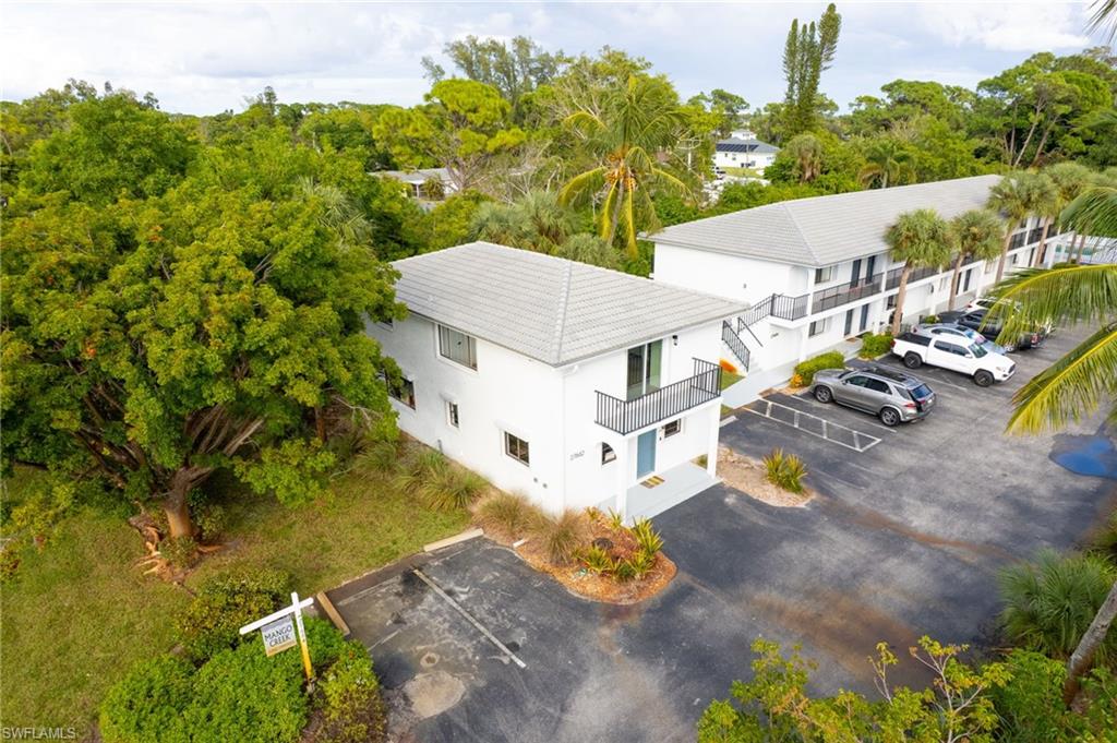 27682 Imperial River Road, Unit CH2 Bonita Springs, FL 34134 - Photo 23 of 26 an aerial view of a house with swimming pool and large trees