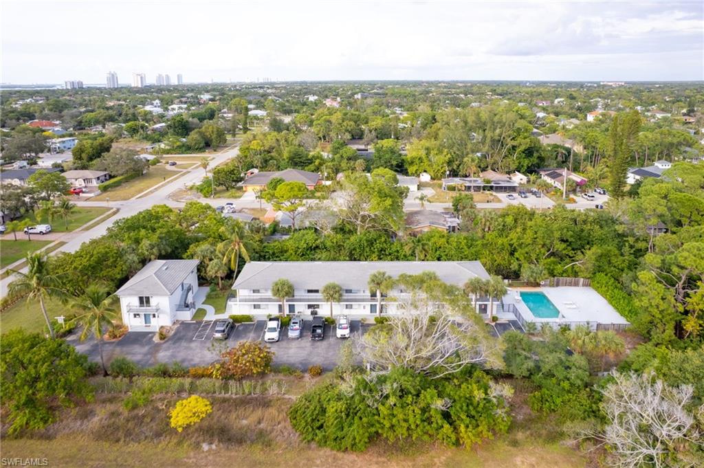 27682 Imperial River Road, Unit CH2 Bonita Springs, FL 34134 - Photo 25 of 26 an aerial view of residential houses with outdoor space and trees