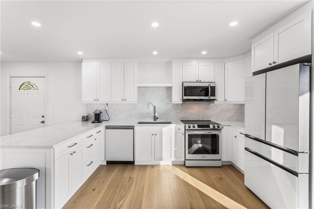 27682 Imperial River Road, Unit CH2 Bonita Springs, FL 34134 - Photo 5 of 26 a kitchen with white cabinets stainless steel appliances and sink