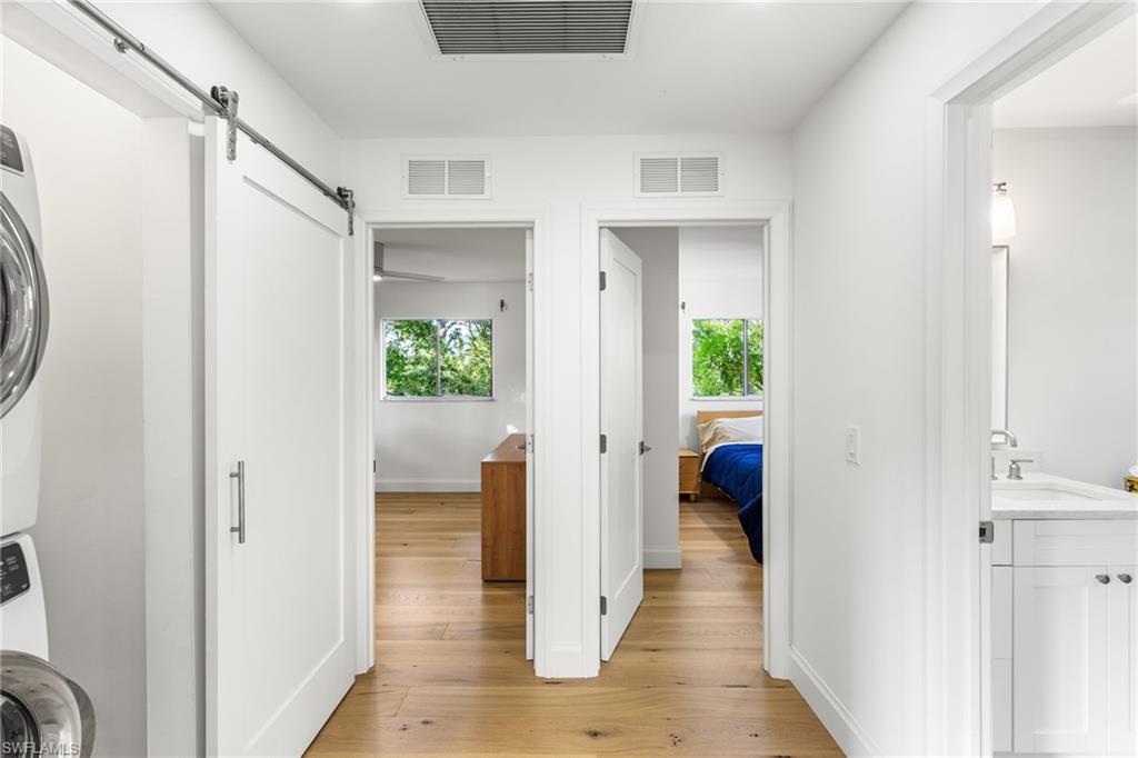 27682 Imperial River Road, Unit CH2 Bonita Springs, FL 34134 - Photo 8 of 26 a view of a hallway with wooden floor and windows