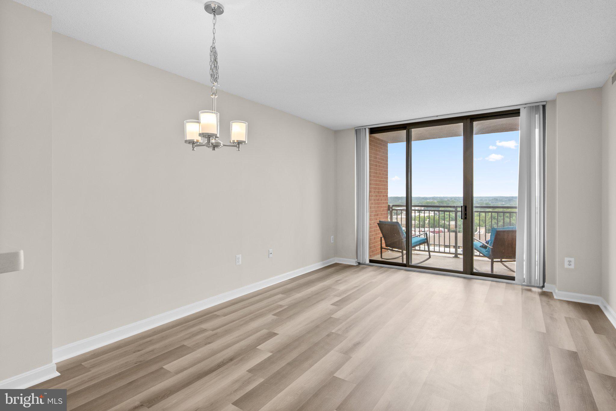11710 Old Georgetown Road, Unit 910 Rockville, MD 20852 - Photo 11 of 47 Living cum dining space that leads to a balcony
