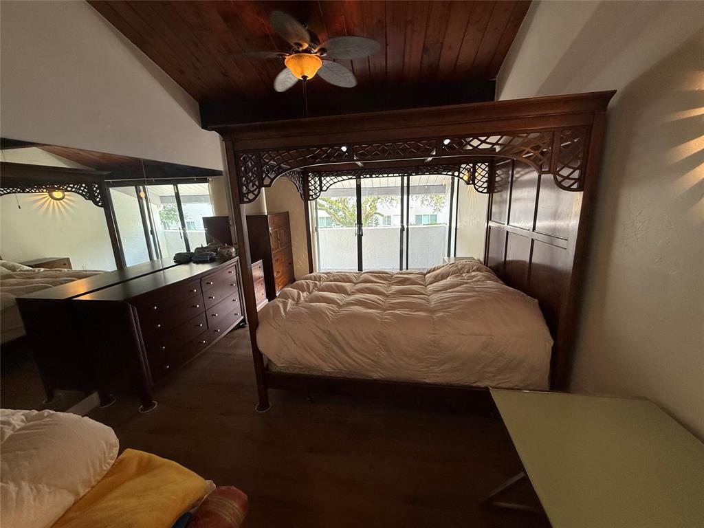 19428 Northeast 26th Avenue, Unit 103 Miami, FL 33180 - Photo 21 of 65 a bed sitting in a bedroom next to a window