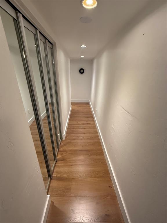 19428 Northeast 26th Avenue, Unit 103 Miami, FL 33180 - Photo 33 of 65 a view of a hallway with wooden floor and stairs
