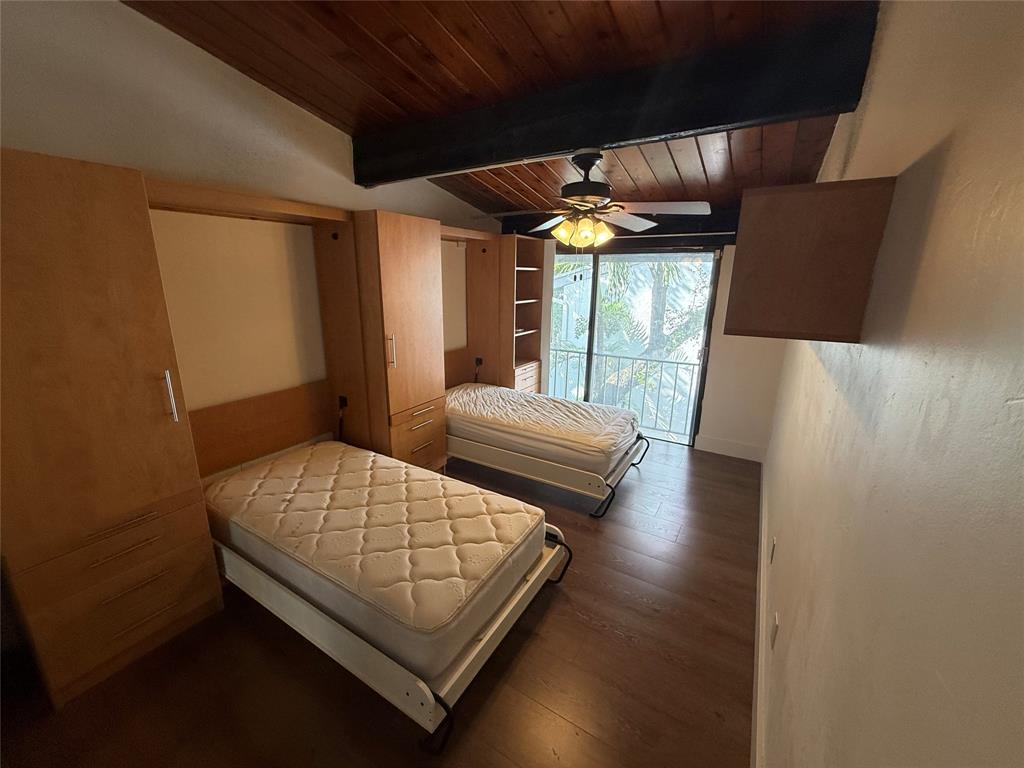 19428 Northeast 26th Avenue, Unit 103 Miami, FL 33180 - Photo 35 of 65 a bedroom with a bed and a large window