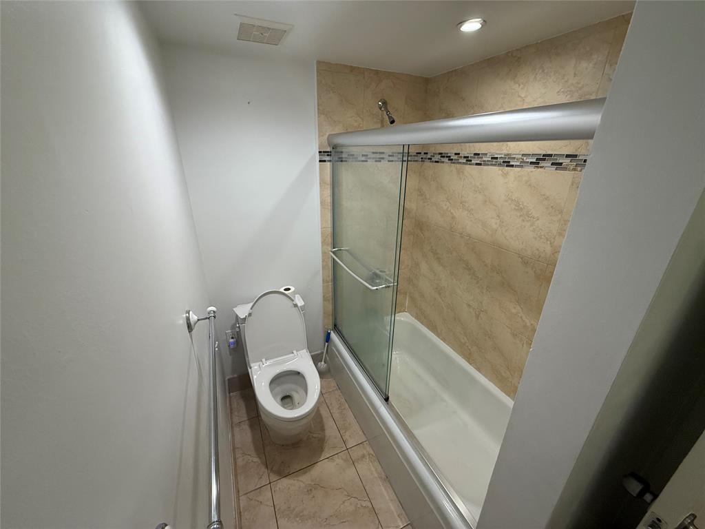 19428 Northeast 26th Avenue, Unit 103 Miami, FL 33180 - Photo 42 of 65 a bathroom with a shower and toilet