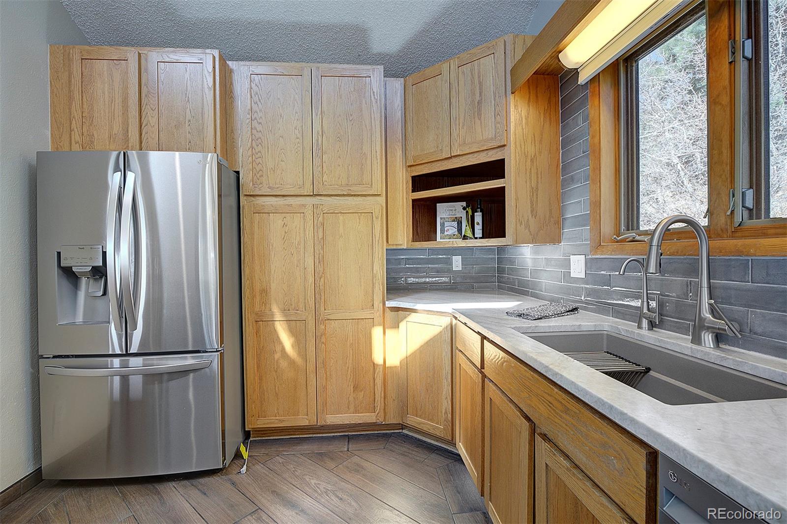 6561 Ridgeview Drive Morrison, CO 80465 - Photo 13 of 36 a kitchen with a refrigerator and a sink