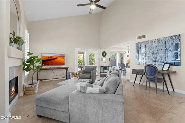 a living room with furniture a table and a potted plant