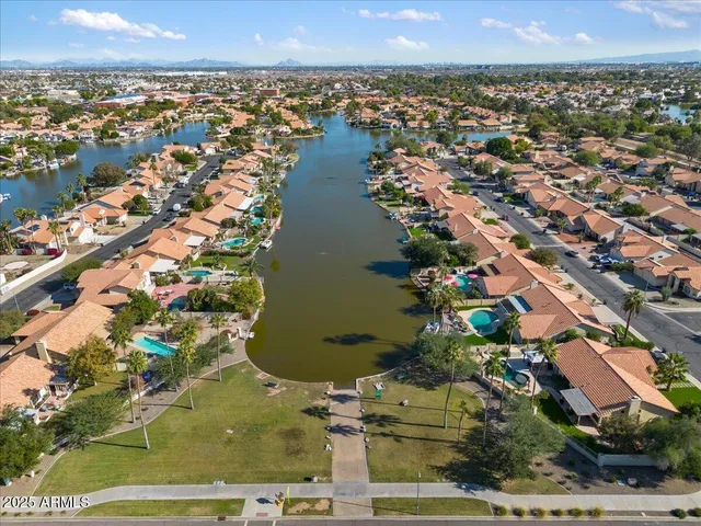 an aerial view of a residential houses with swimming pool and outdoor space