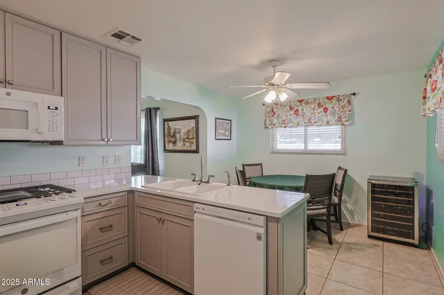 a kitchen that has a sink and a stove in it