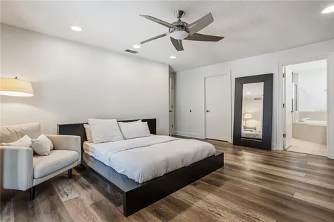 a bedroom with a large bed and a couch