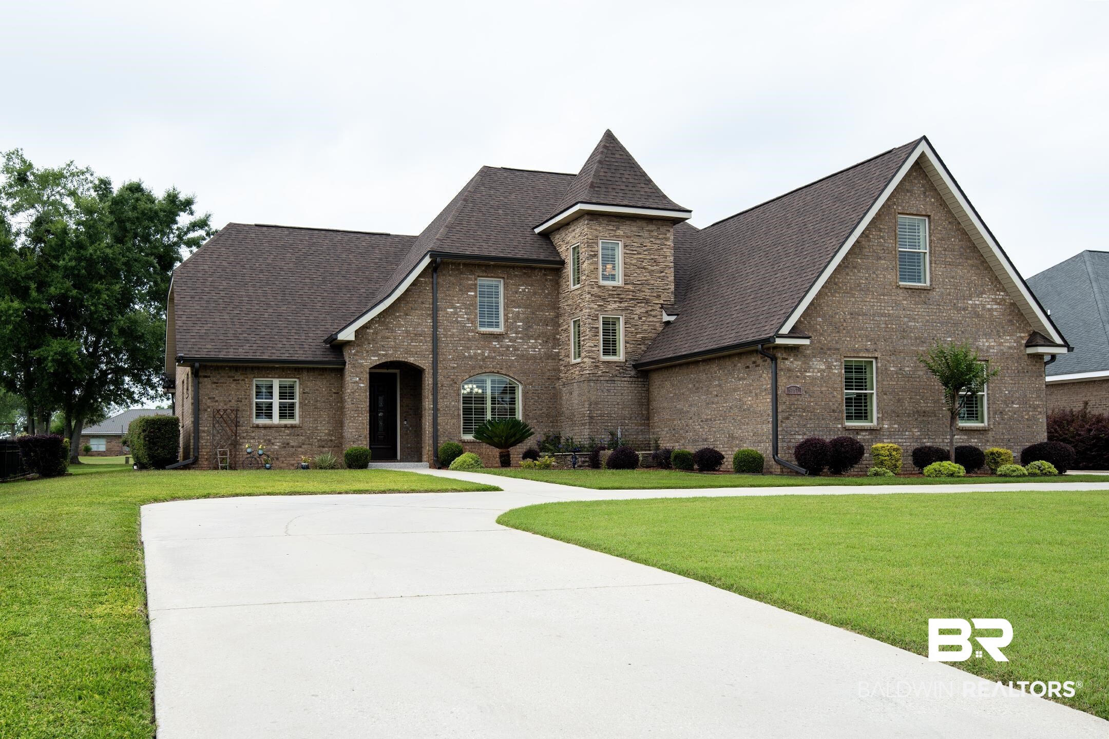 9357 Lakeview Drive Foley, AL 36535 - Photo 8 of 68 Brick exterior featuring a prominent turret and multiple gabled rooflines