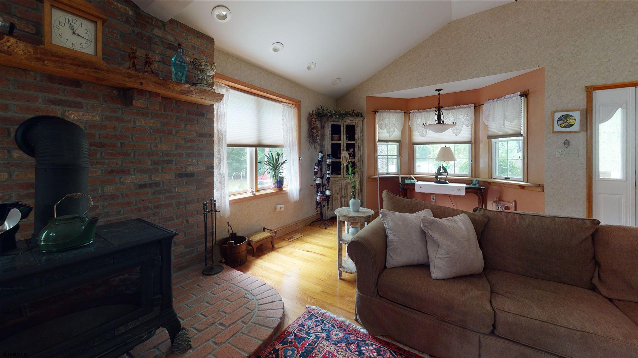 105 Tyler Road Ocean View, NJ 08230 - Photo 12 of 43 a living room with furniture fireplace and windows
