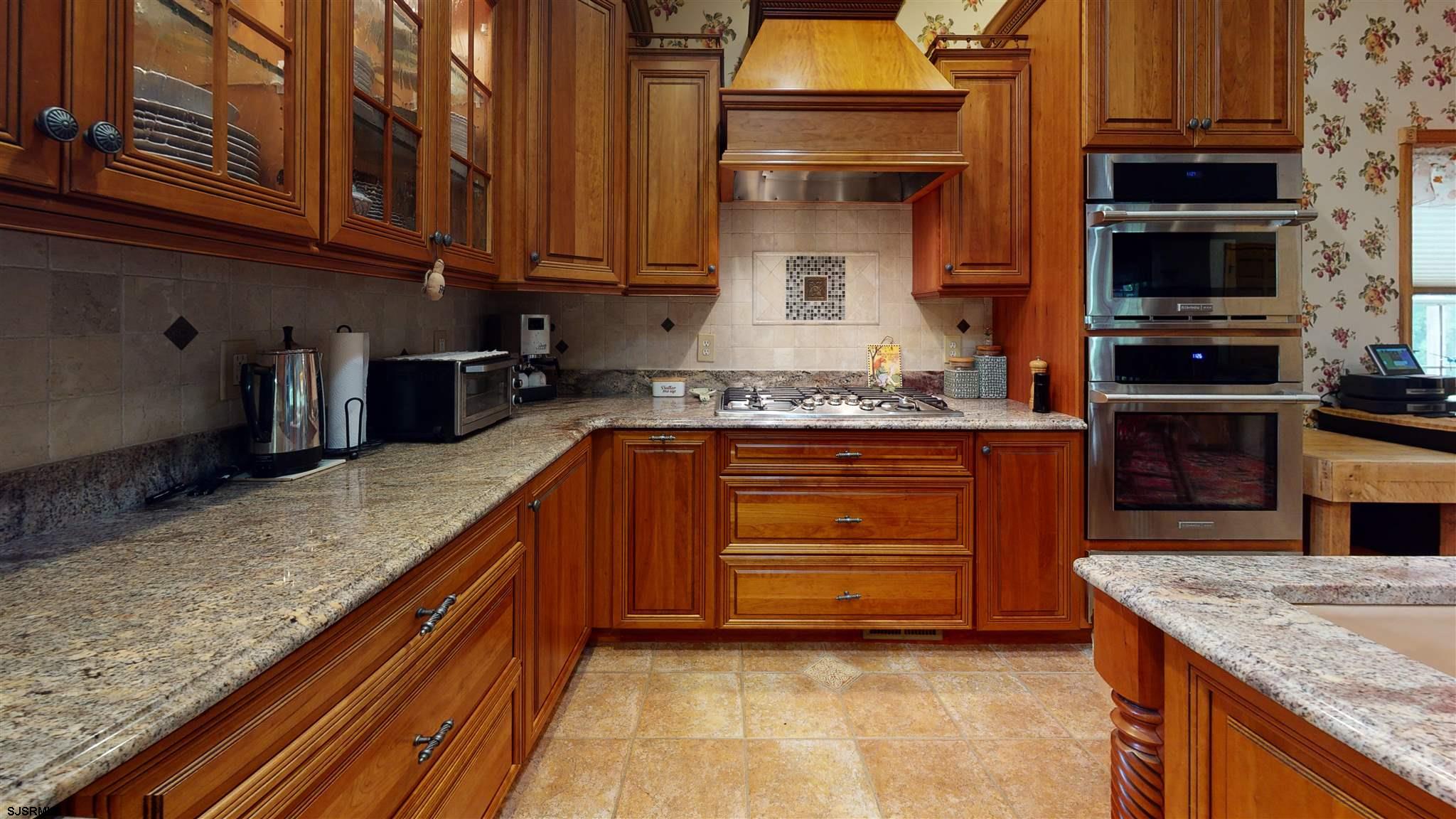 105 Tyler Road Ocean View, NJ 08230 - Photo 16 of 43 a kitchen with stainless steel appliances granite countertop a stove and a sink